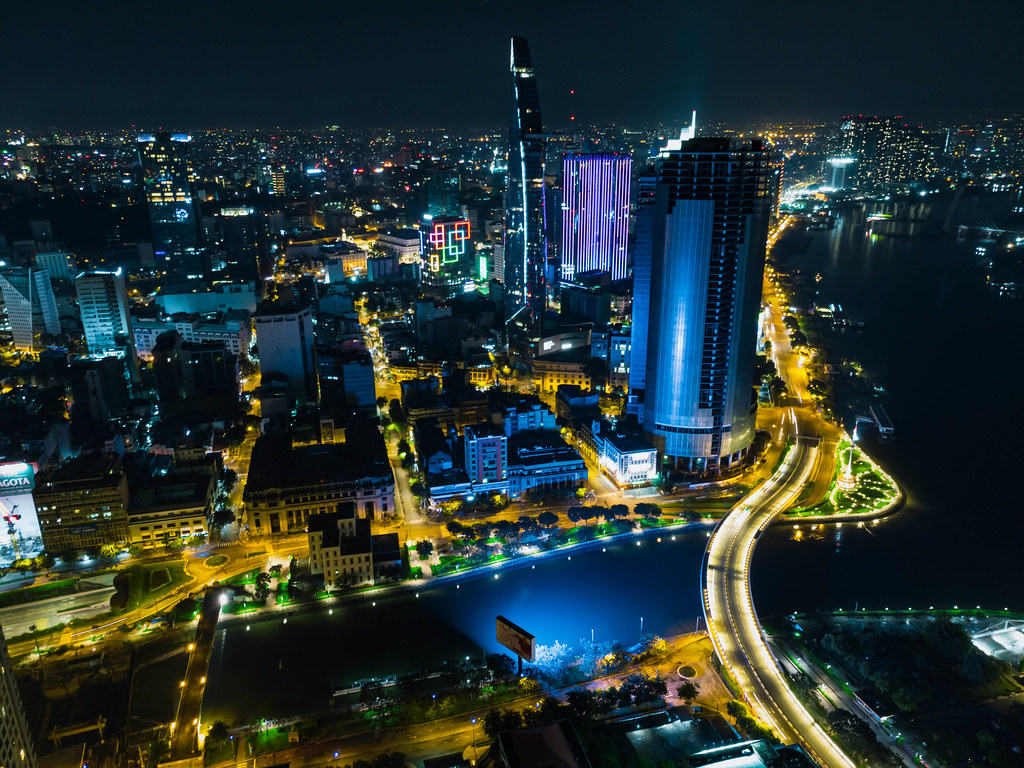 Night Drone Photo of the City Center of Ho Chi Minh City, Vietnam with Bitexco Financial Tower, Saigon One and Saigon River