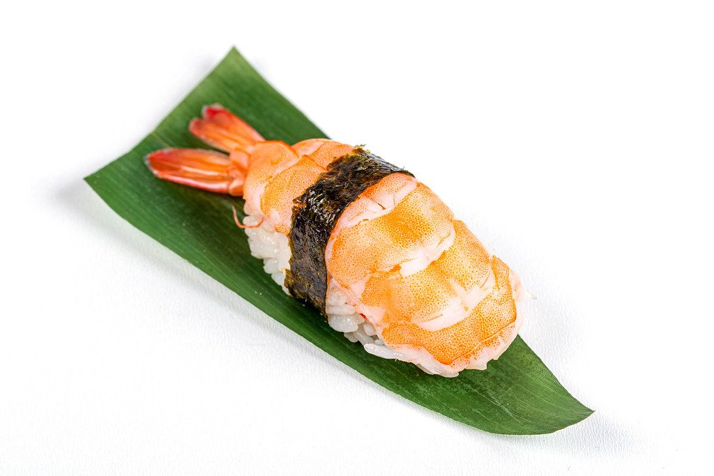 Nigiri with shrimp on a green leaf