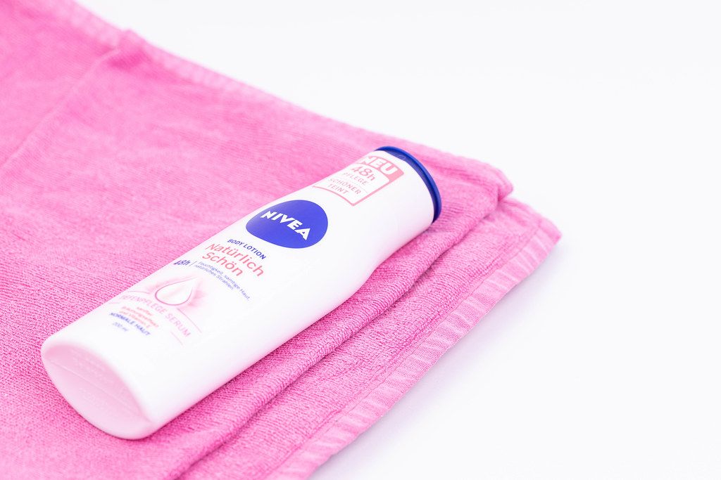 Nivea cosmetics on the towel with copy space