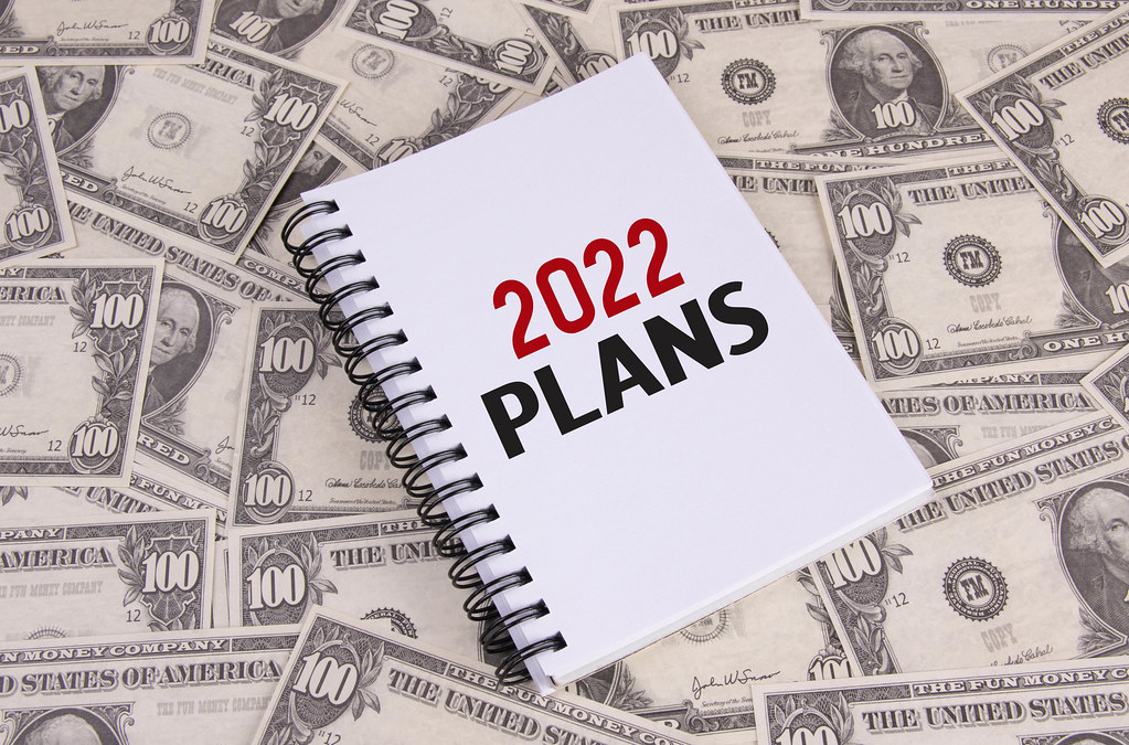 Notebook with 2022 Plans text on dollar banknotes