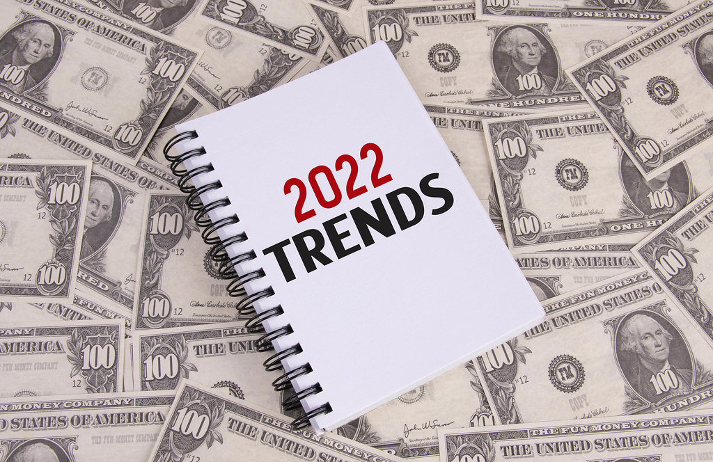 Notebook with 2022 Trends text on dollar banknotes