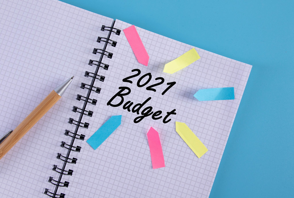 Notebook with arrows pointing at 2021 Budget text
