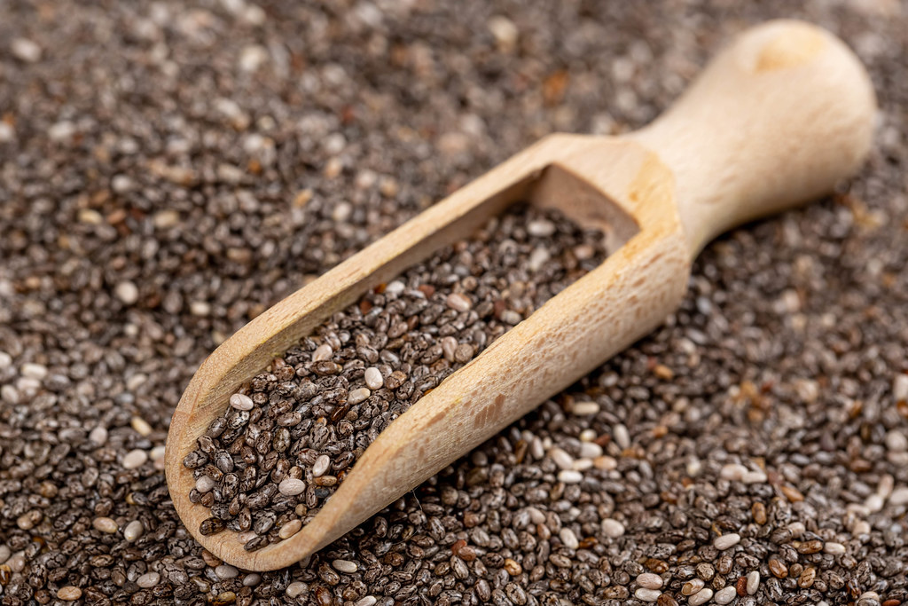 Nutritious chia seeds in wooden spoon