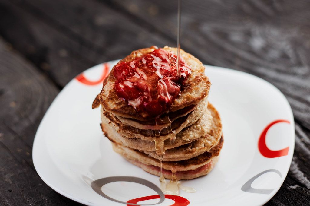 Oatmeal pancakes with strawberry jam and honey