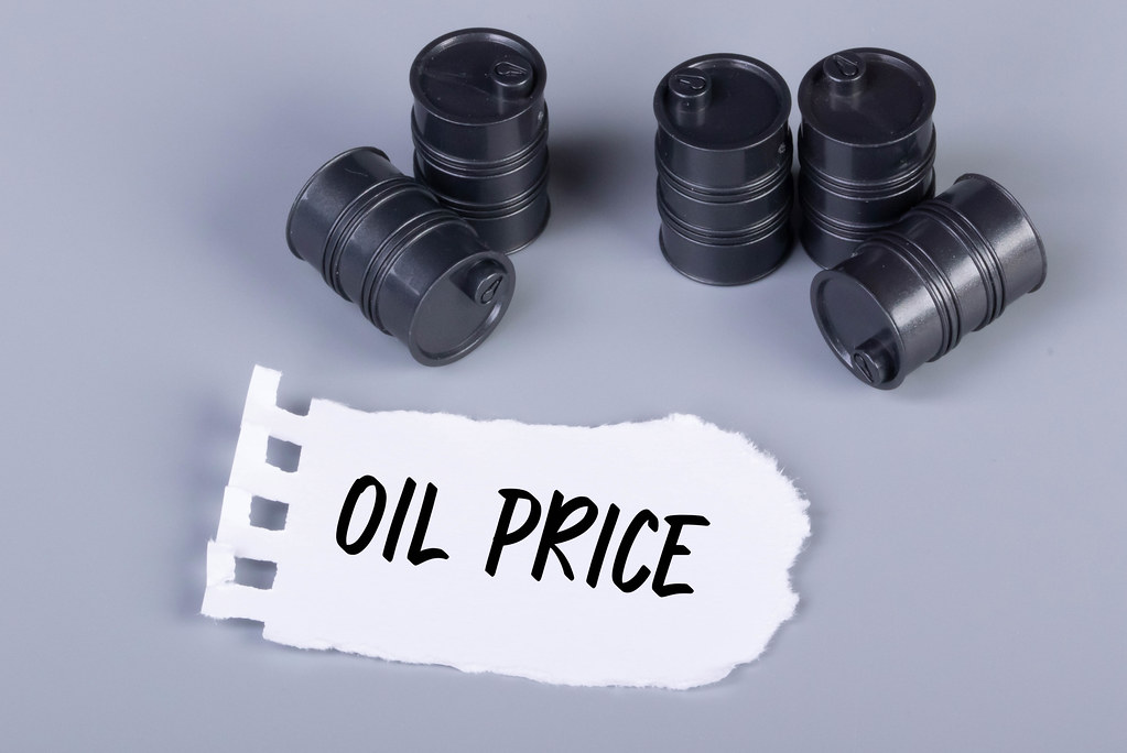 Oil barrels and piece of paper with Oil Price text