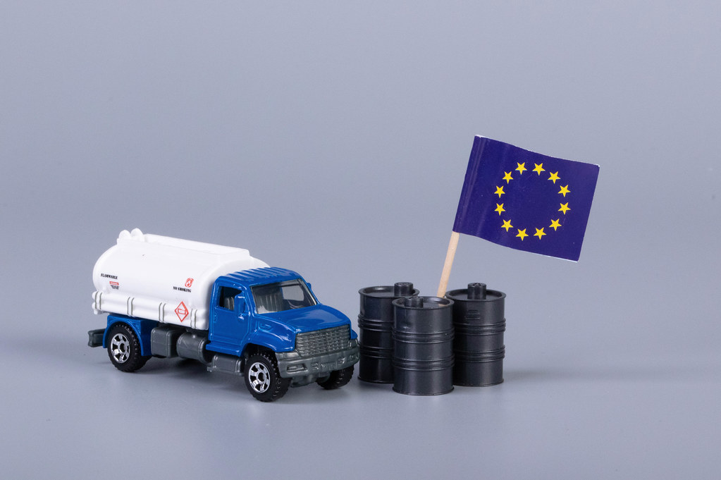 Oil truck and oil barrels with flag of European Union