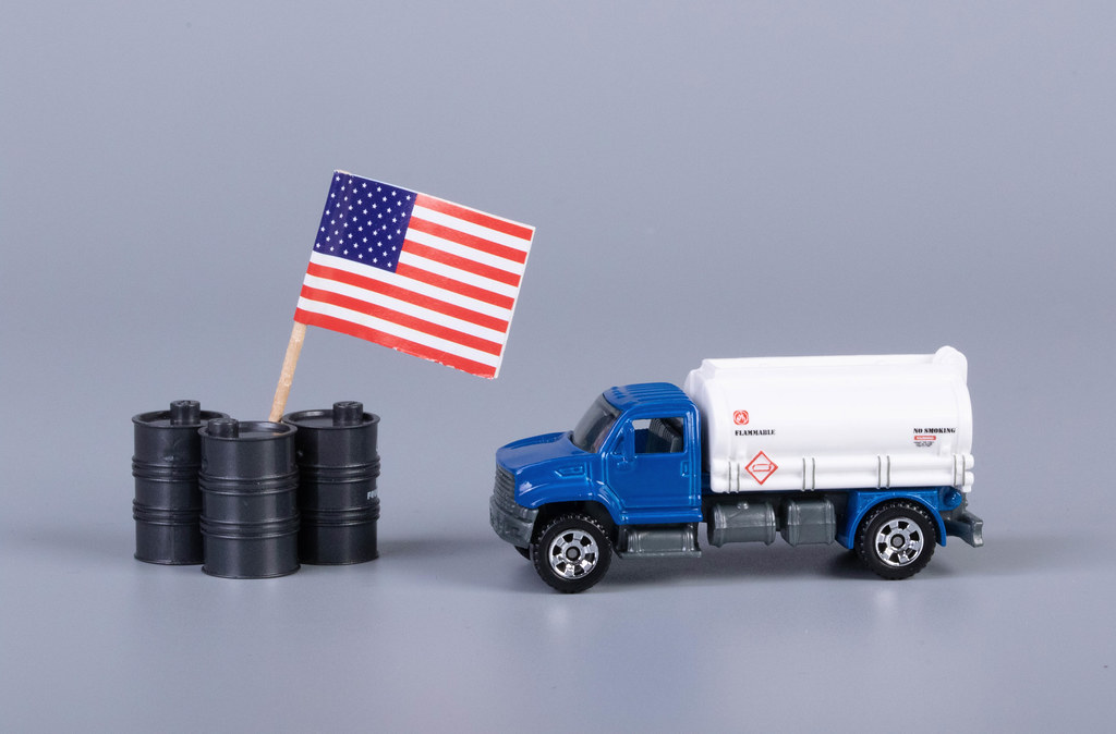 Oil truck and oil barrels with flag of United States of America