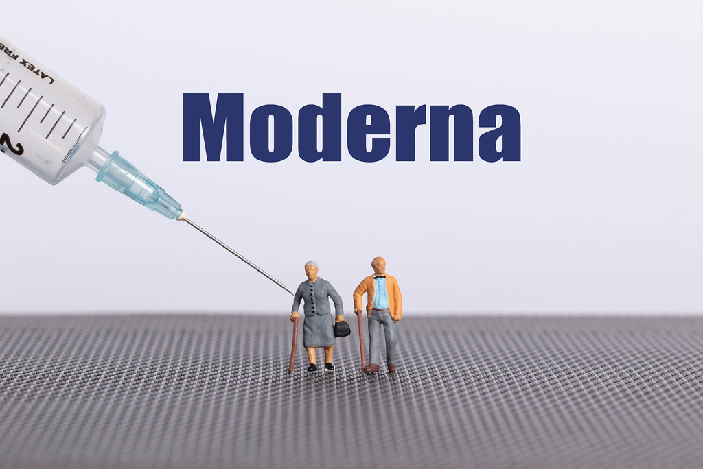 Older couple with syringe and Moderna text