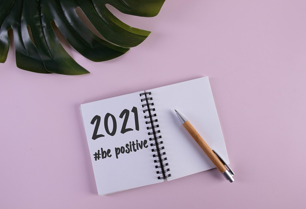 Open notebook with 2021 Be positive text