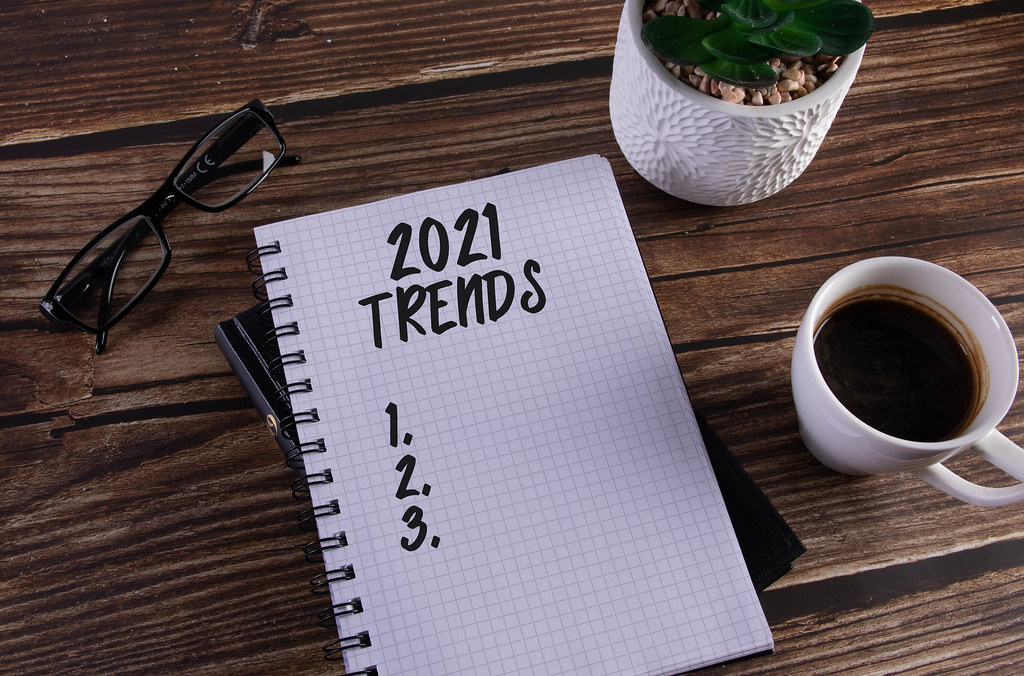 Open notebook with 2021 Trends text on wooden table