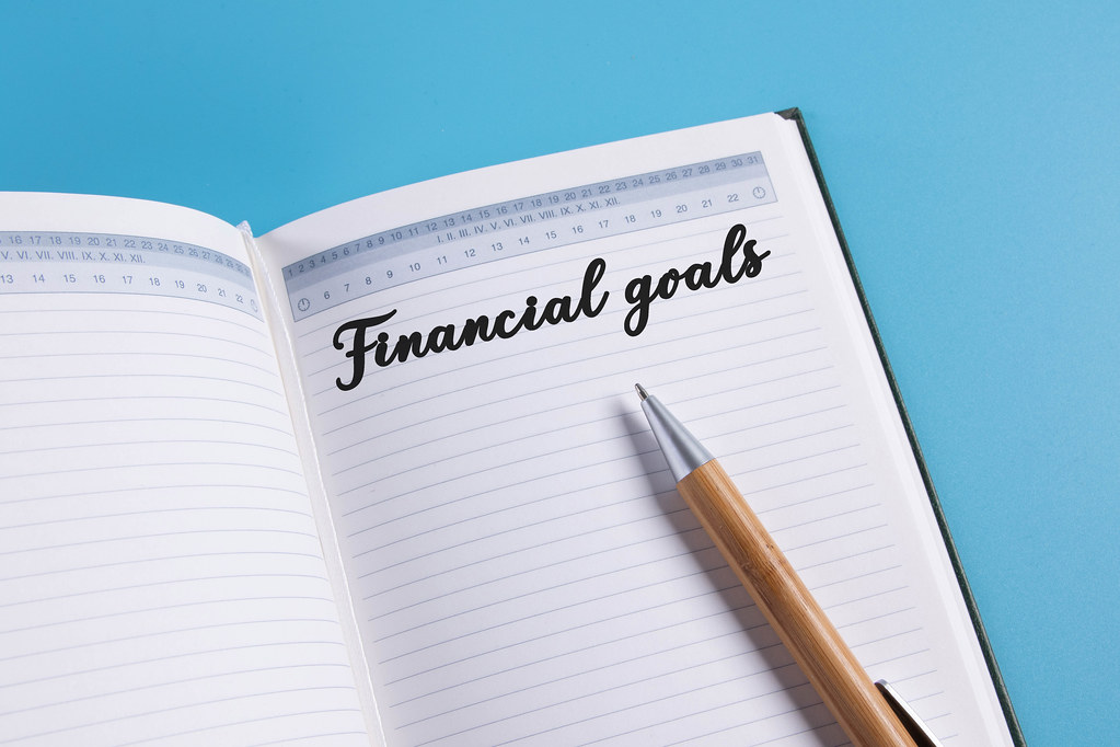 Open notebook with Financial goals text on blue background