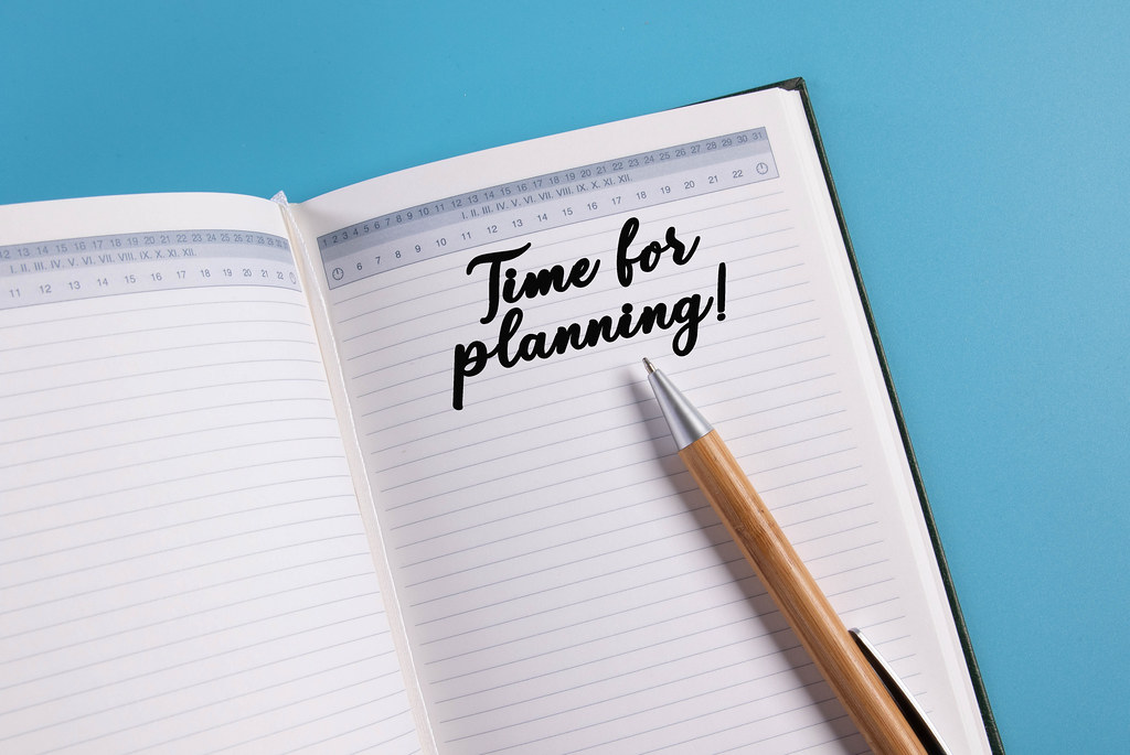 Open notebook with Time for planning text on blue background