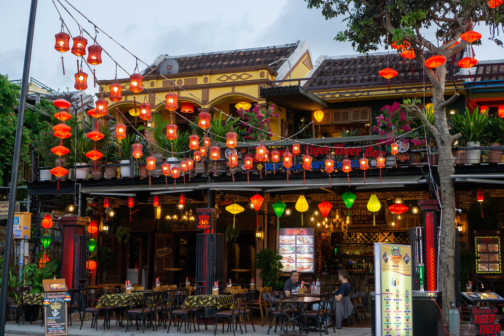 Open Restaurant with many Plants, Lanterns in different Shapes and Colors and Outdoor Seating in the Pedestrian Street in Hoi An, Vietnam