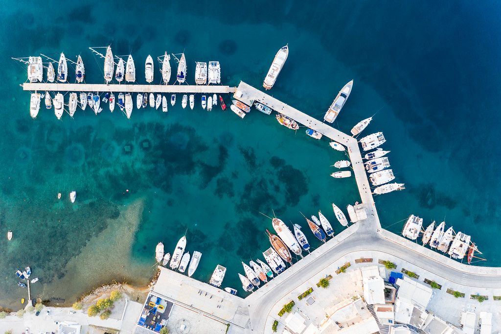 Overhead shot of boats parked at the pier at the port of Adamantas, Milos, South Aegean
