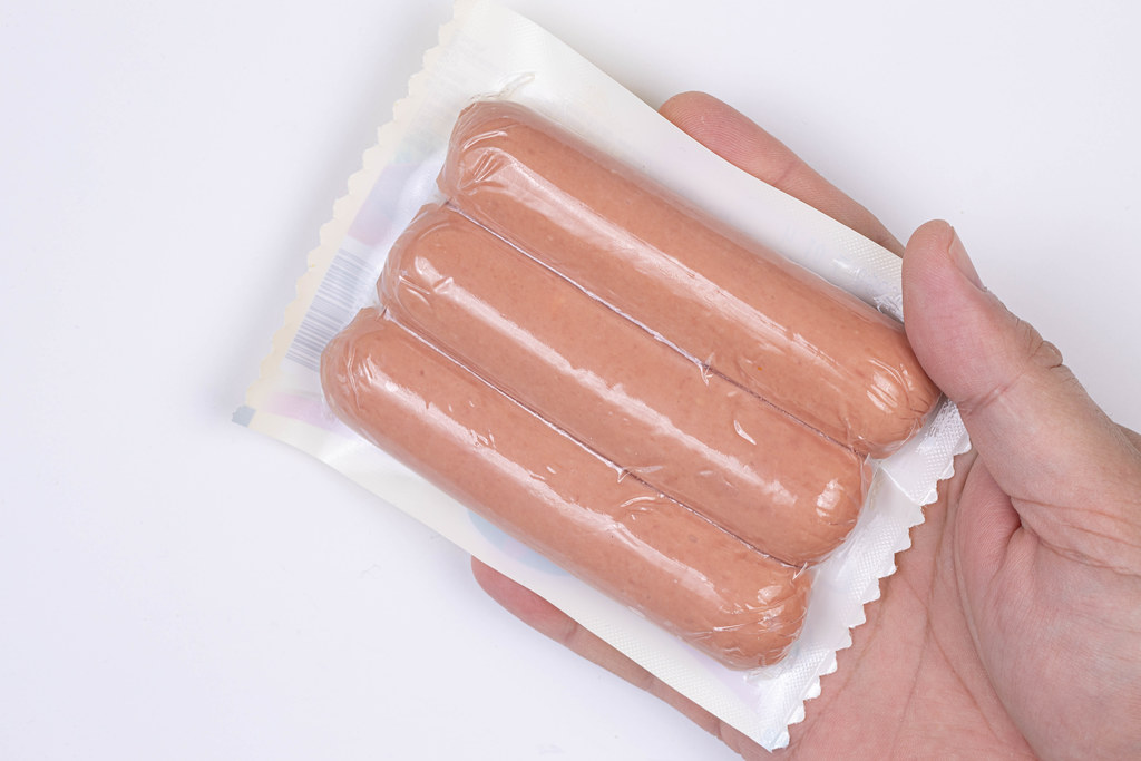 Package of raw Hot Dogs in the plastic bag