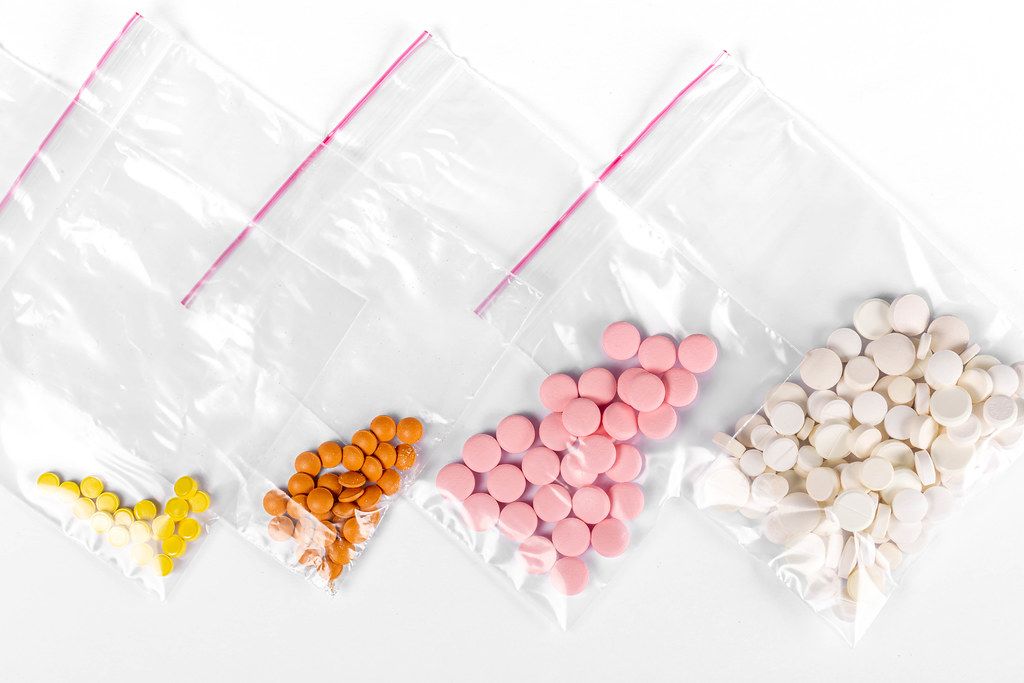 Packages with multi-colored tablets on a white background