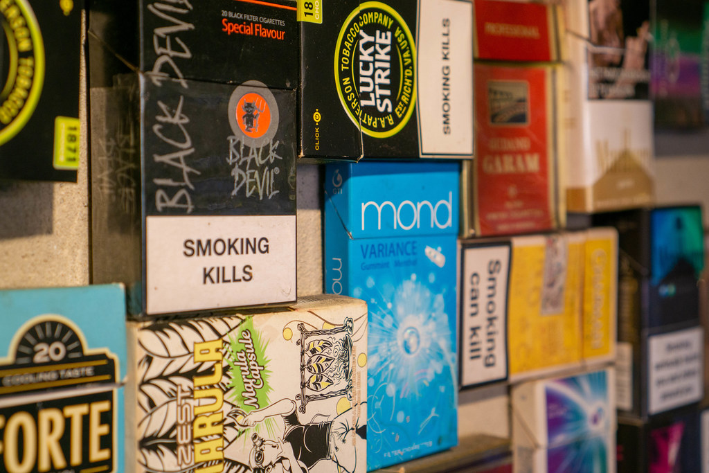 Packs of Cigarettes of Different Brands with Warning Signs and Pictures as Creative Wall Decoration