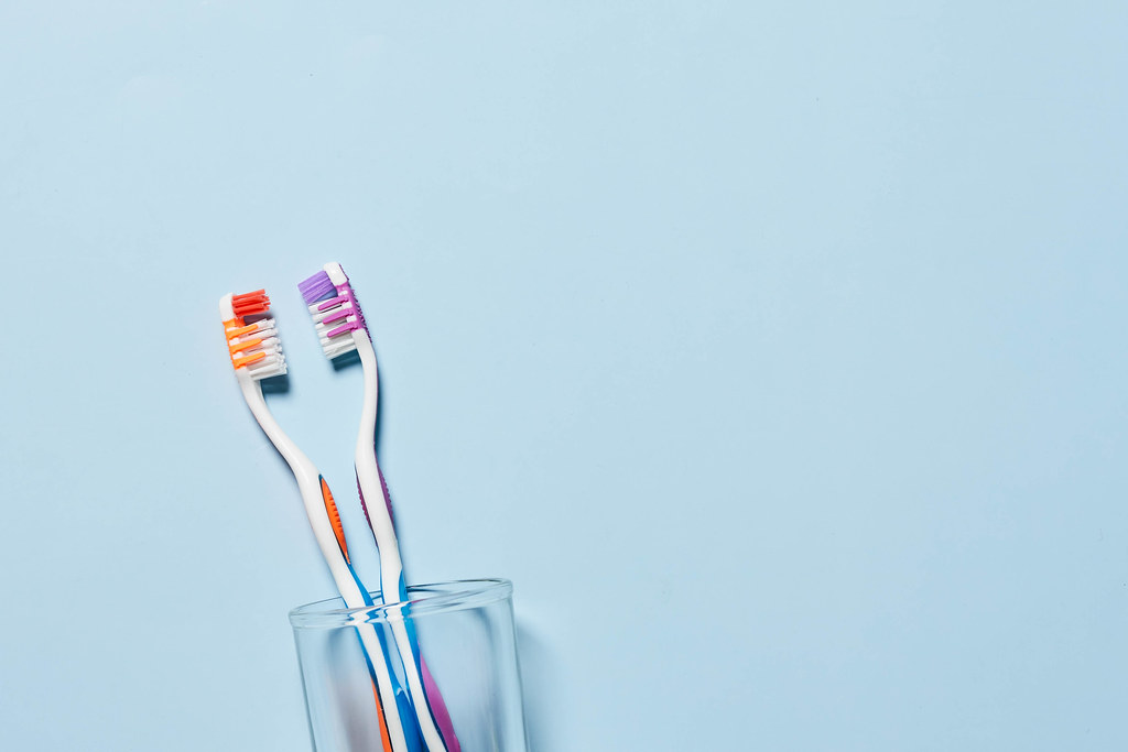 Pair of toothbrushes in a glass
