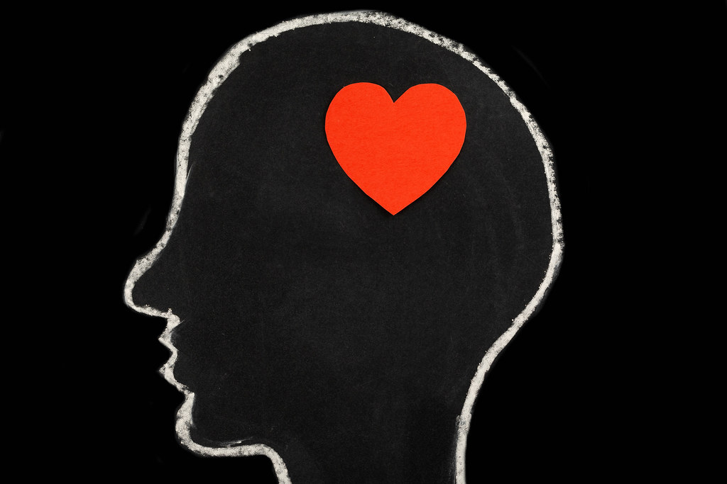 Paper red heart in man's head, concept love