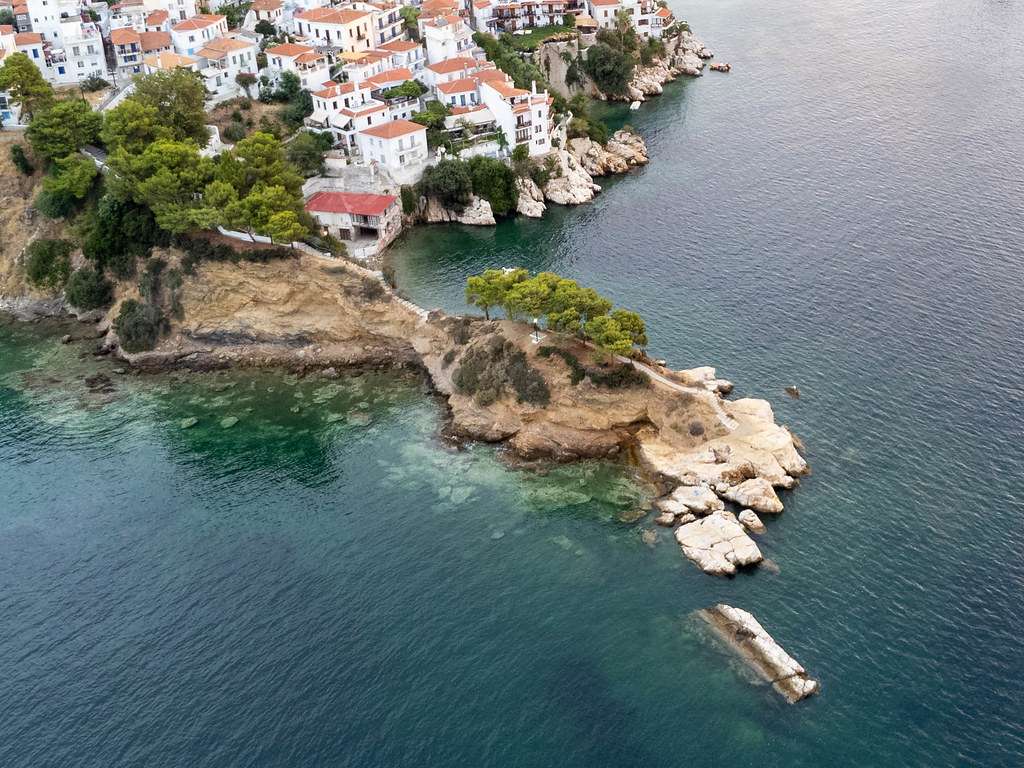 Paralia Plakes: Aerial view of a small rocky paeninsula with a few trees and stairs leading to the sea on Skiathos