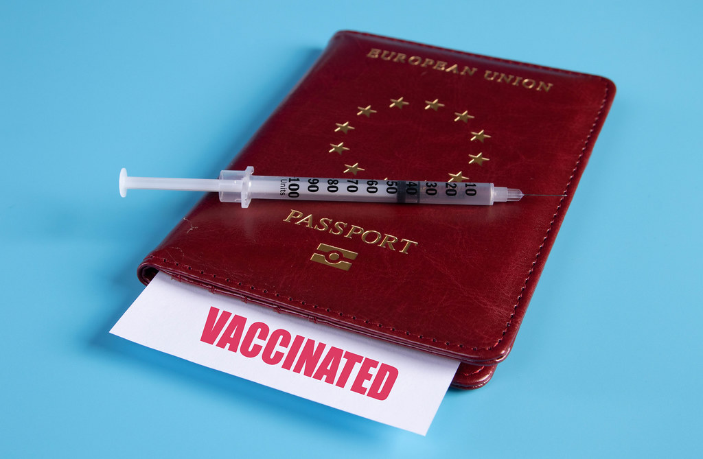 Passport with syringe and Vaccinated card
