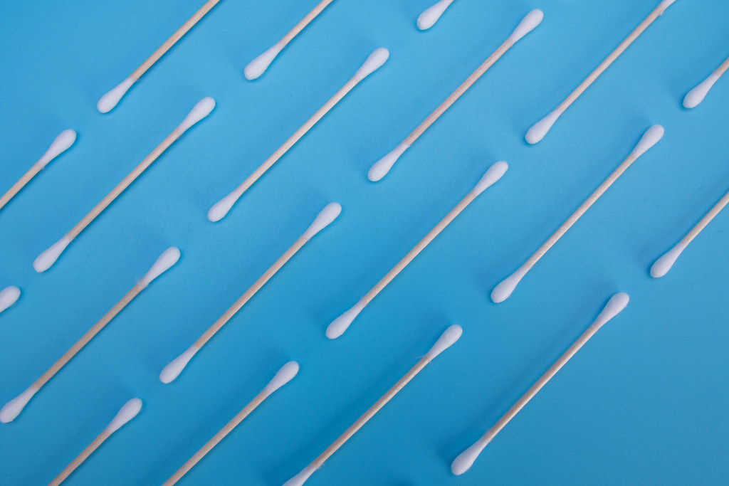 Pattern of zero waste bamboo cotton buds on a blue background