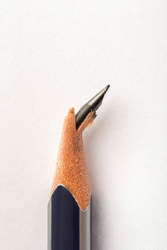 Pencil with broken tip on white background