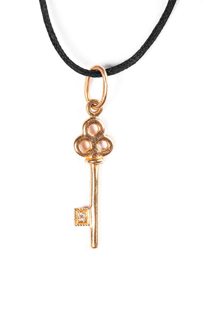 Pendant gold key with black cord
