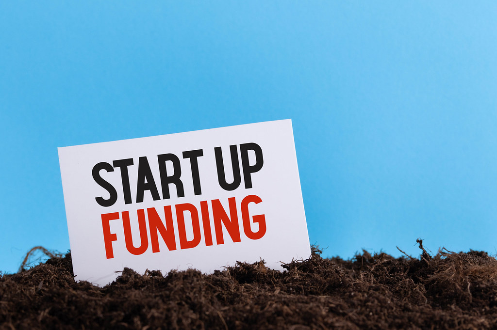 Piece of paper with Start Up Funding text on a dirt