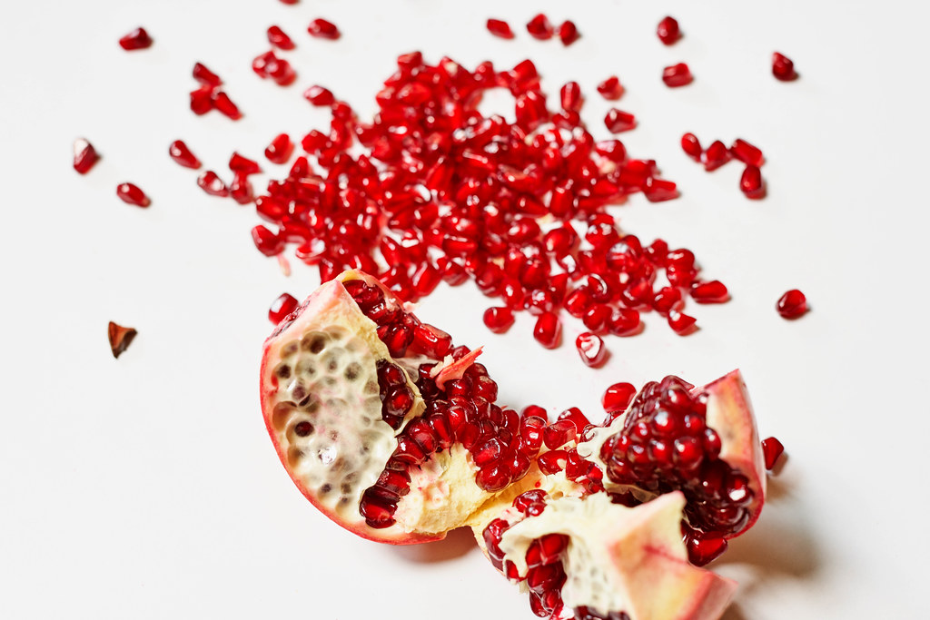 Piece of pomegranate and heap of seeds