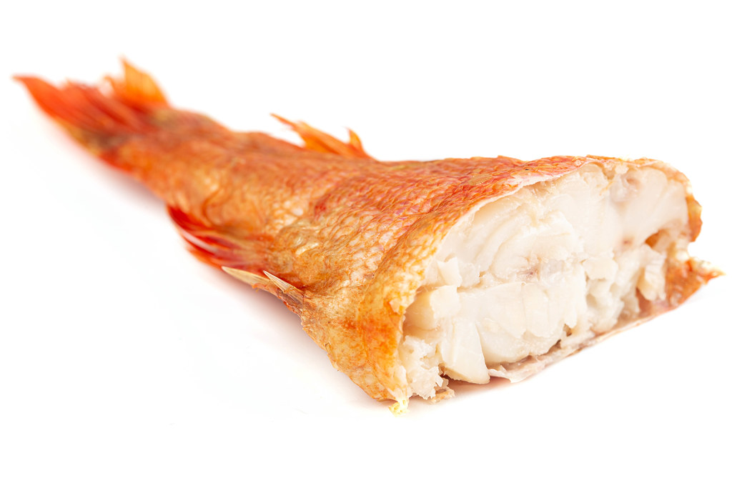Piece smoked fish, ocean perch on white background