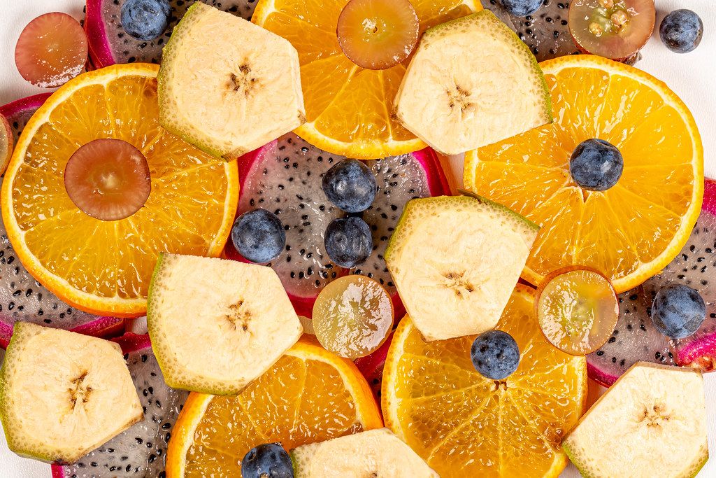 Pieces of tropical fruit and berries-fruit background