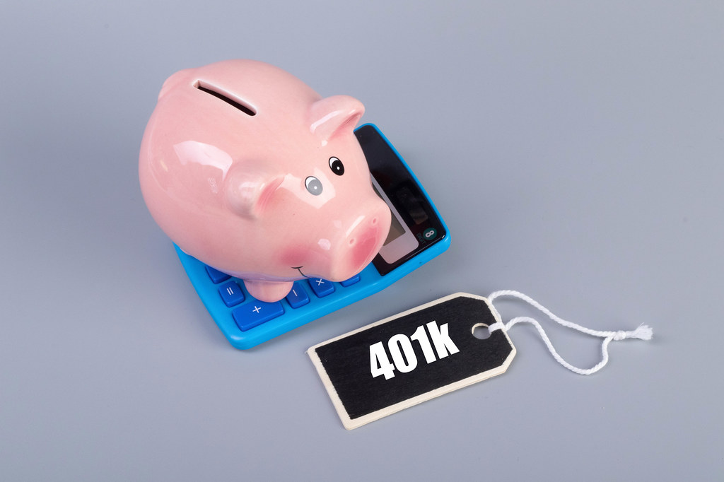 Piggybank on a calculator and 401k text