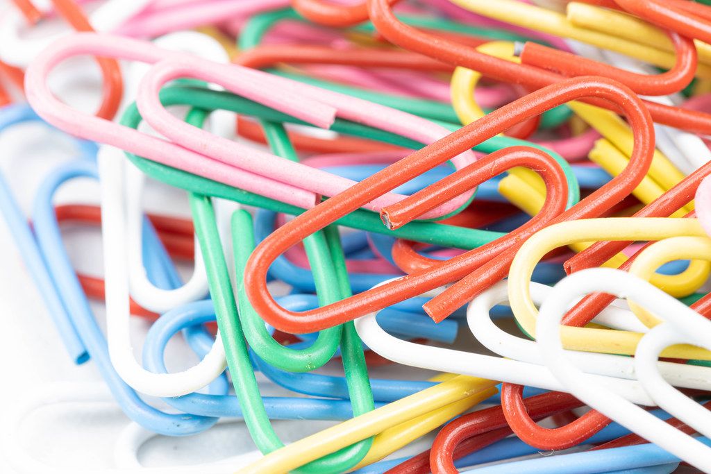Pile of colorful Paper Clips in macro closeup image