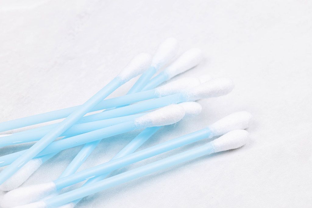 Pile of Ear Swab sticks isolated above white background