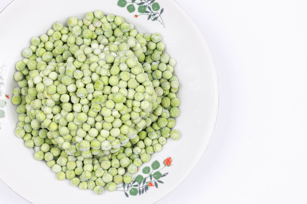 Pile of frozen Green Peas on the plate