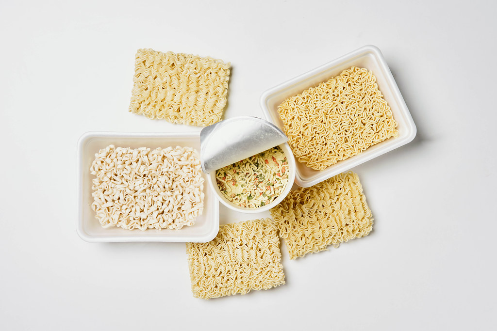 Pile of raw dry uncooked instant noodles on white background