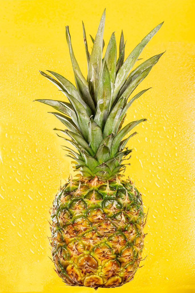 Pineapple tropical fruit on yellow