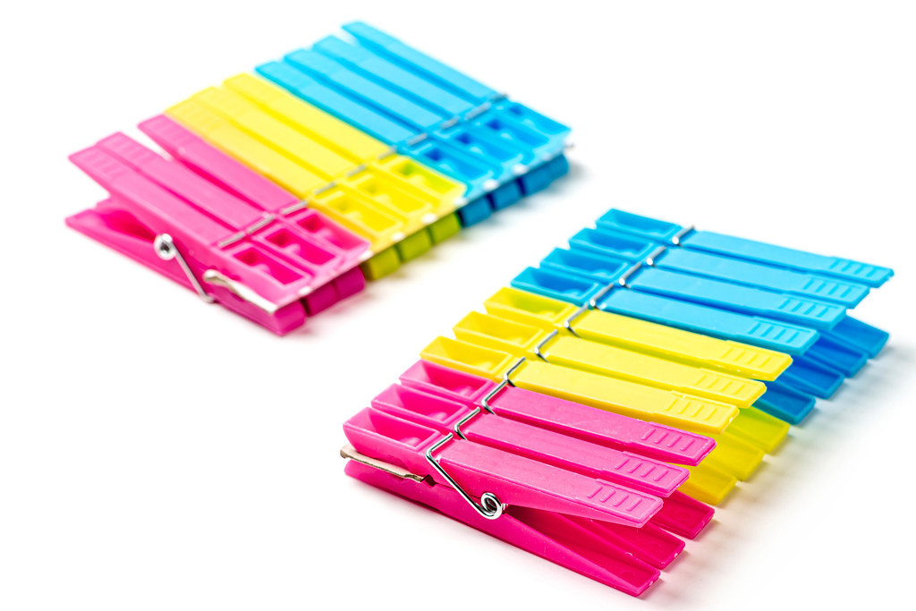 Pink, yellow and blue plastic clothespins