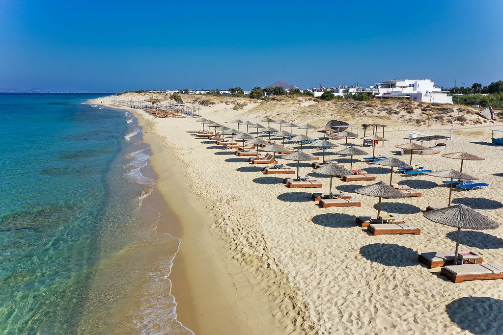 Plaka beach on Naxos, Greece: three rows of parasols at dream beach without tourists
