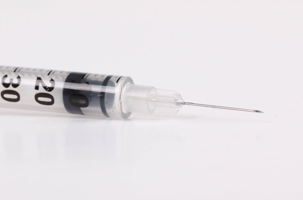 Plastic insulin syringe isolated on white background
