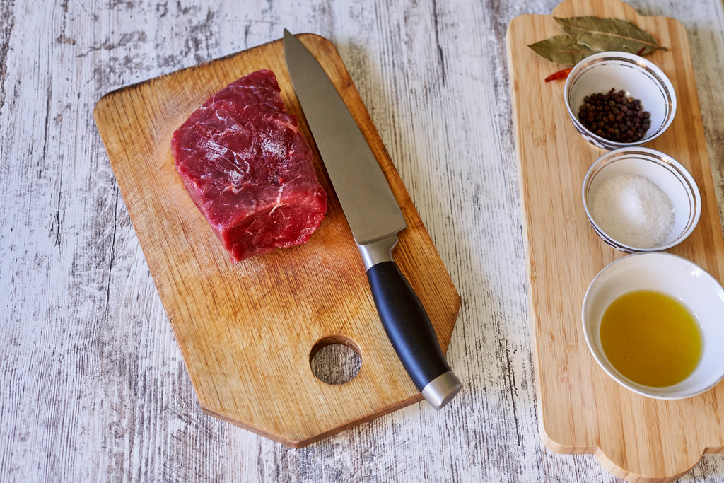 Preparing raw meat for cooking steak