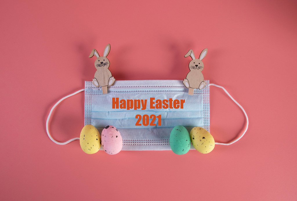 Protective face mask with easter decorations and Happy Easter 2021 text