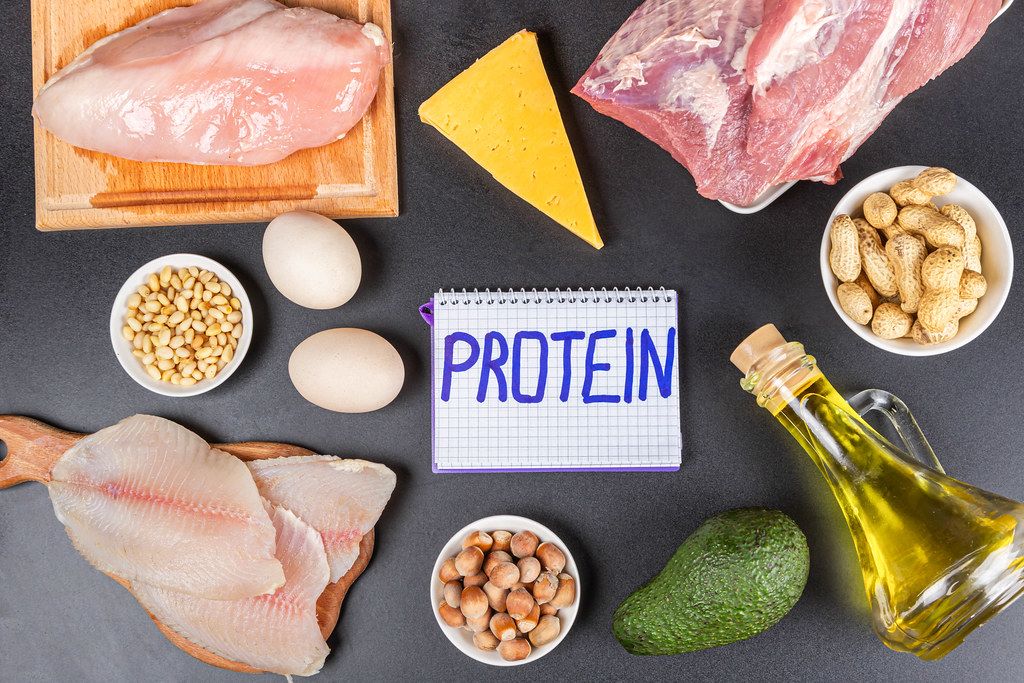 Protein diet products on a black background with an inscription in the center
