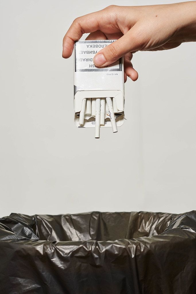 Quit smoking concept - throwing cigarettes into the trash