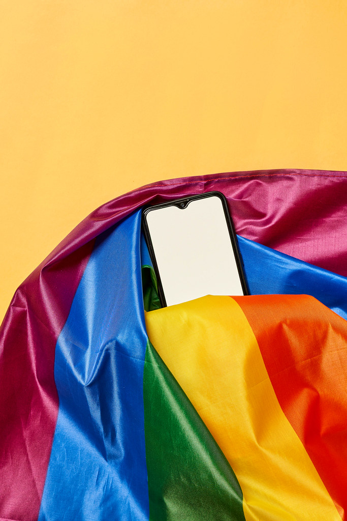 Rainbow flag and a smartphone with empty white screen