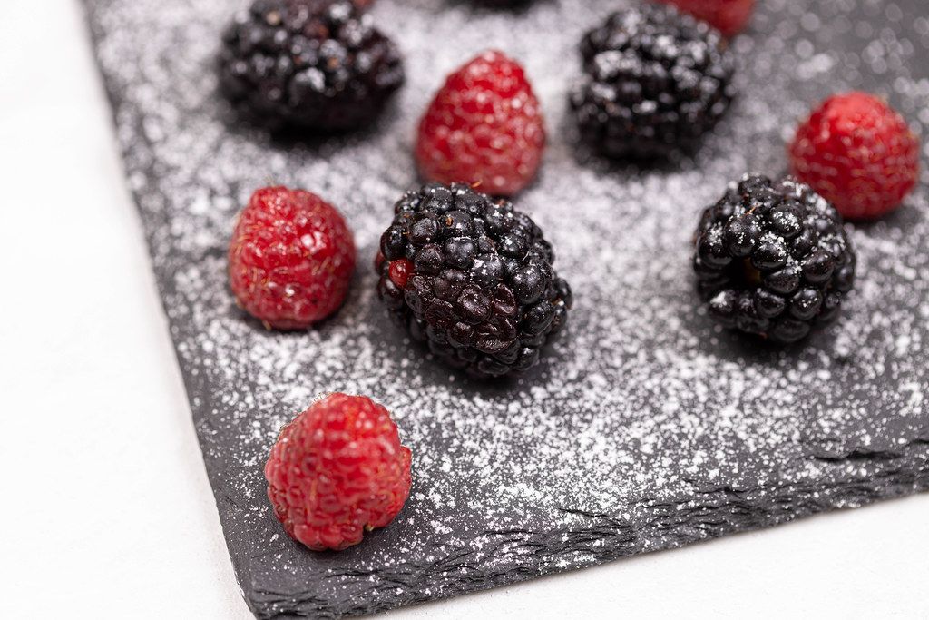 Raspberries and Blackberries sprinkled with powdered sugar