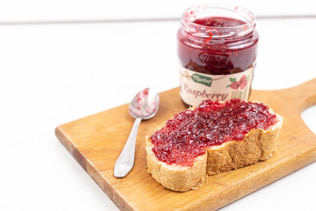 Raspberry Jam in the jar and bread with jam