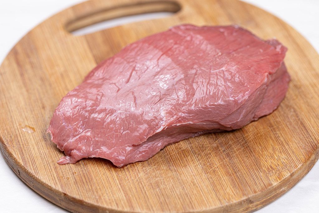 Raw Beef Meat slice on the wooden board