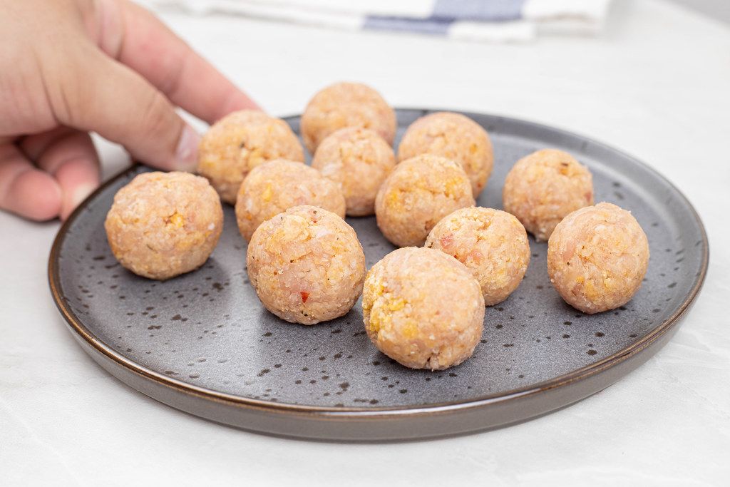 Raw Chicken Meatballs on the plate ready for frying
